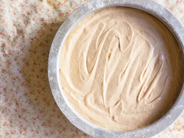Cake batter in a round pan.