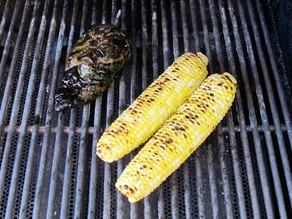 Corn cobs and poblano pepper on the grill.