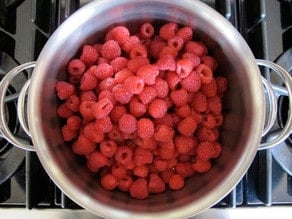 Fresh raspberries in a saucepan.