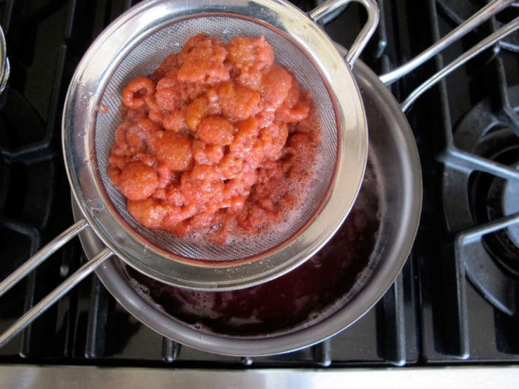 Removing raspberries from boiled water.