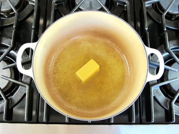 Melting butter and lard in a Dutch oven.