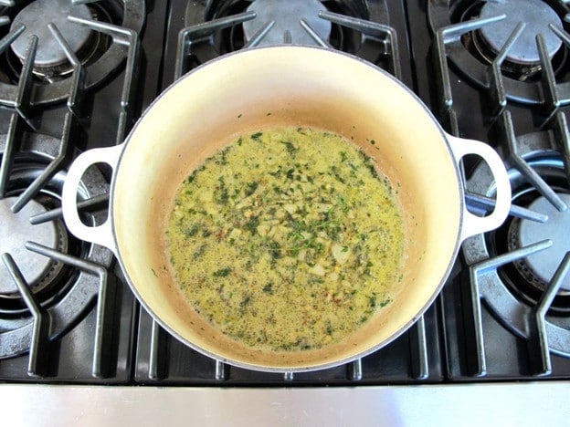 Seasoned diced onion in a Dutch oven.