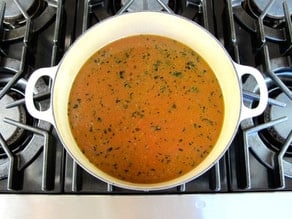 Broth simmering in a Dutch oven.