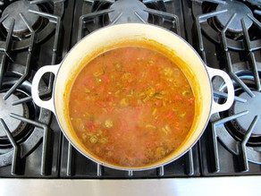 Okra soup simmering in a Dutch oven.