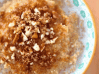 A bowl of Maple Brown Sugar Quinoa Porridge topped with chopped nuts