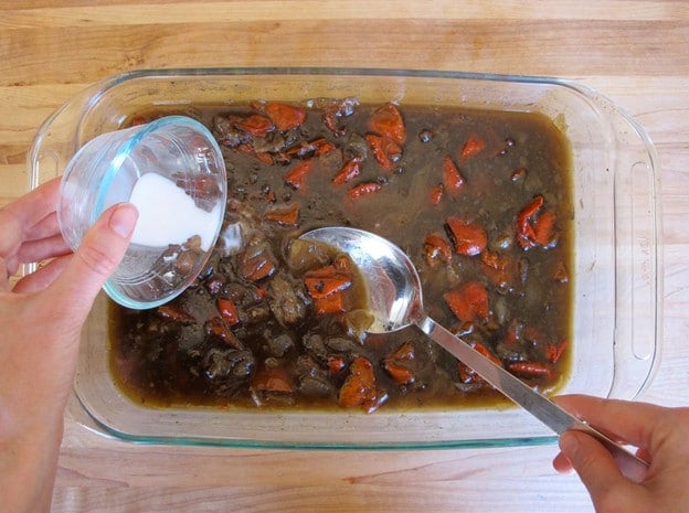 Stirring cornstarch slurry into beef drippings.