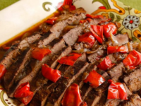 Sliced beef with peppers marinated and cooked in a blend of rum and coffeee