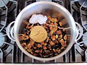 Spices and figs in a stock pot.