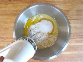 Mixer beating flour into egg mixture.