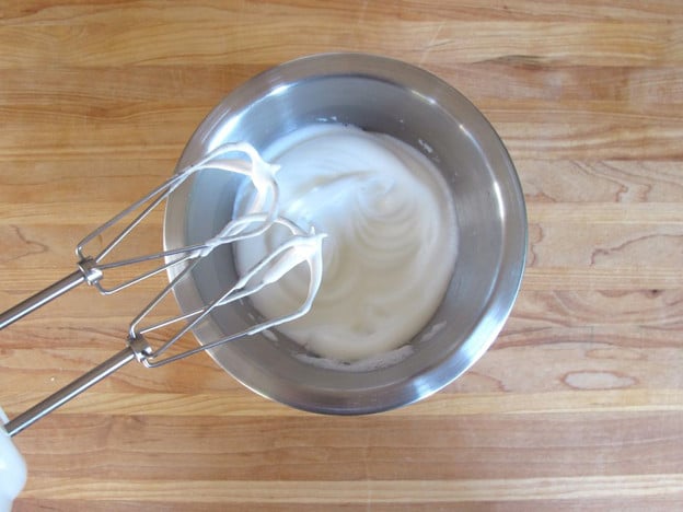 Beating egg whites until stiff.
