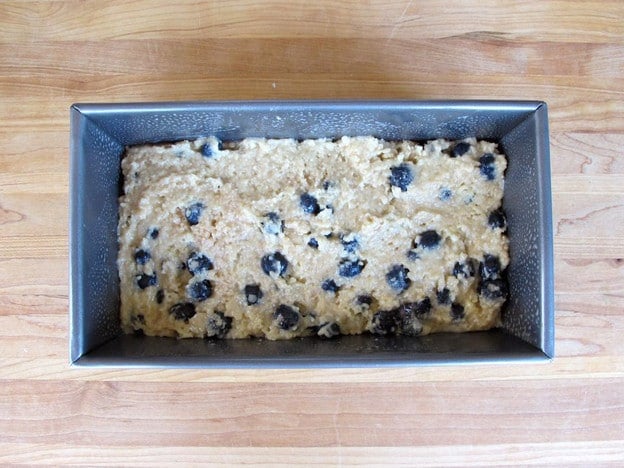 Blueberry cake batter in a loaf pan.