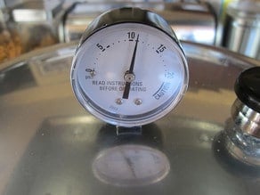 Pointer of gauge on pressure canner lid pointing at 11.