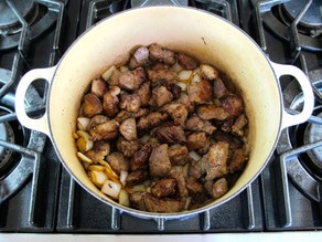 Lamb, potatoes, and onion in a stockpot.
