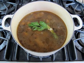 Herb bouquet in stockpot of stew.