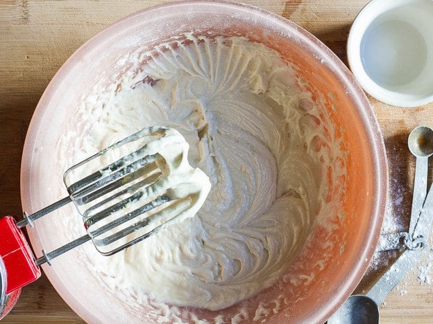 Beat cake batter with a mixer.