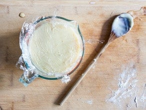 Stirring butter into milk.