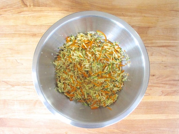 Combine all grated vegetables in a bowl.