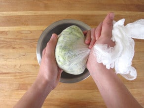 Wrapping shredded vegetables in cheesecloth for straining.