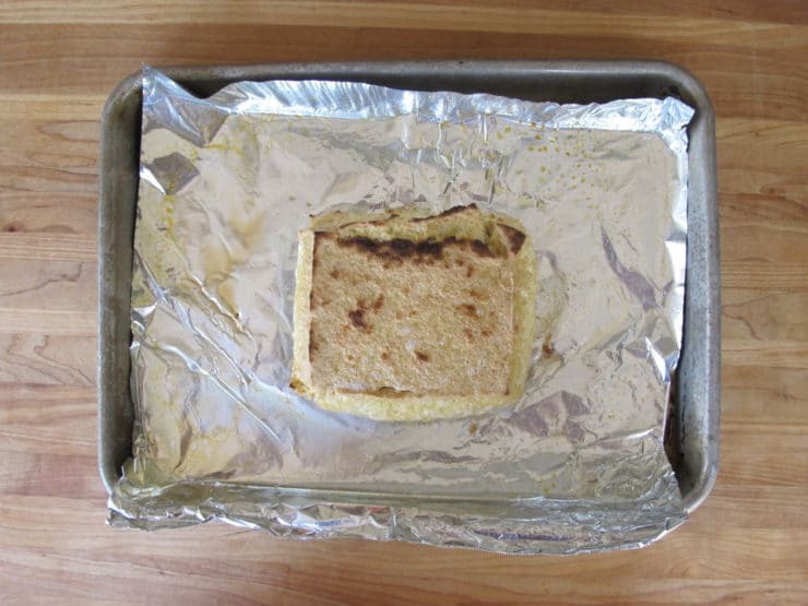 Broiled tofu on a baking sheet.