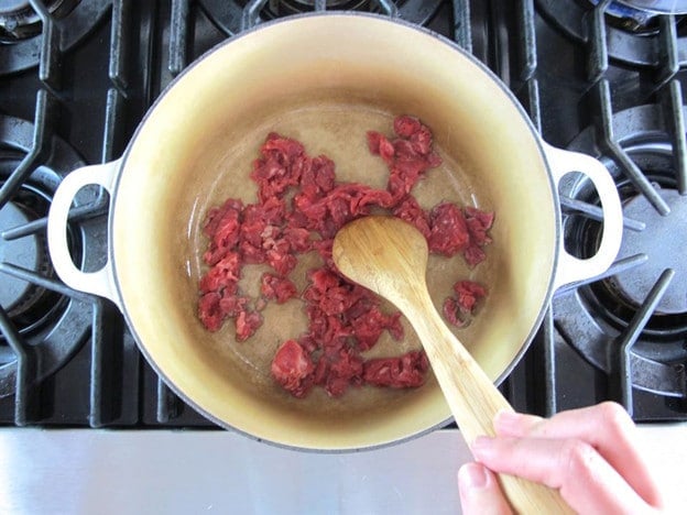 Browning beef in a stockpot.