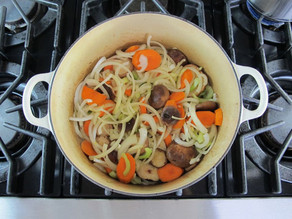 Sauteeing vegetables in a stock pot.