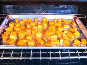 Roasting cubed butternut squash in oven.