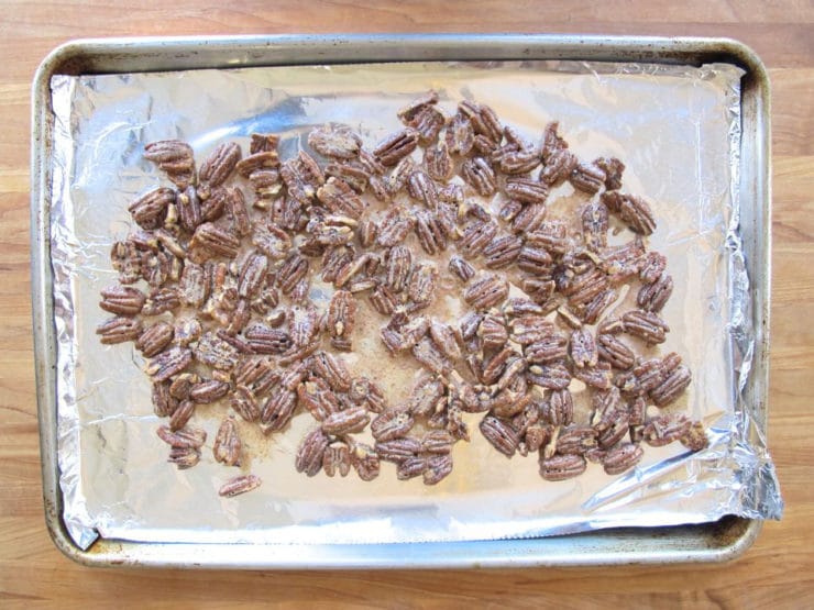 Baked pecans on a baking sheet.