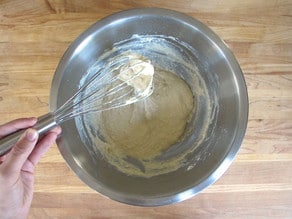Adding flour to beaten egg.