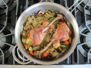 Roasted turkey legs and diced vegetables on the stove.