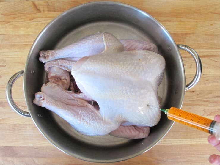 Injecting marinade into turkey.