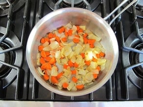 Carrots and onions in a skillet.