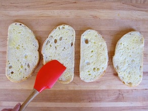 Buttering sliced bread.