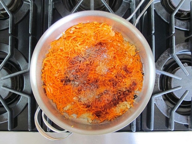 Shredded carrots in a skillet.
