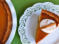 A delicious Macaroon Pumpkin Pie topped with coconut and cinnamon on a white plate
