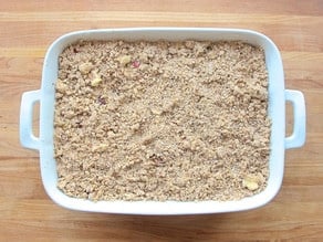 Matzo crisp topping spread over fruit filling in a baking dish.