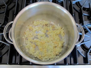 Sauteeing onions in a large stockpot.
