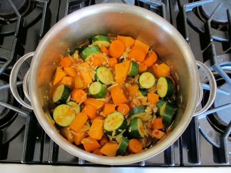 Chopped vegetables added to pot.