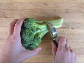 Peeling the outer part of broccoli stems.