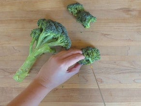 Cutting broccoli into florets.
