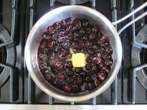 Melting butter into cherries.