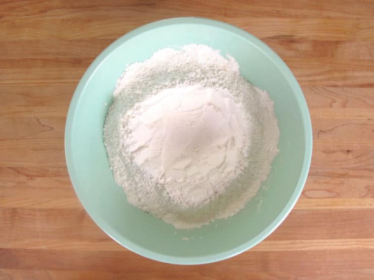 Combining powdered sugar and pulverized almonds.