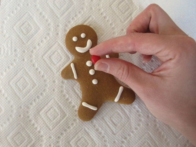 Decorating baked gingerbread men.