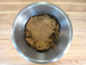 Stirring cookie dough ingredients together in a bowl.