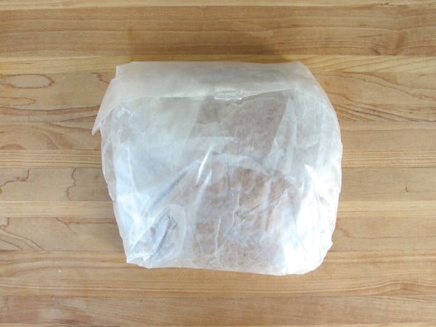 Gingerbread dough wrapped in parchment paper to chill.