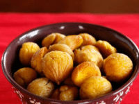 A pile of roasted peeled brown chestnuts with a smooth texture