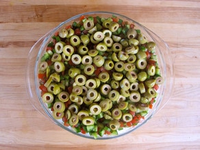 Green olives layered over salad.