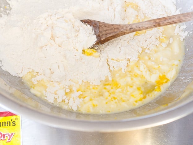 Mixing flour into wet batter.