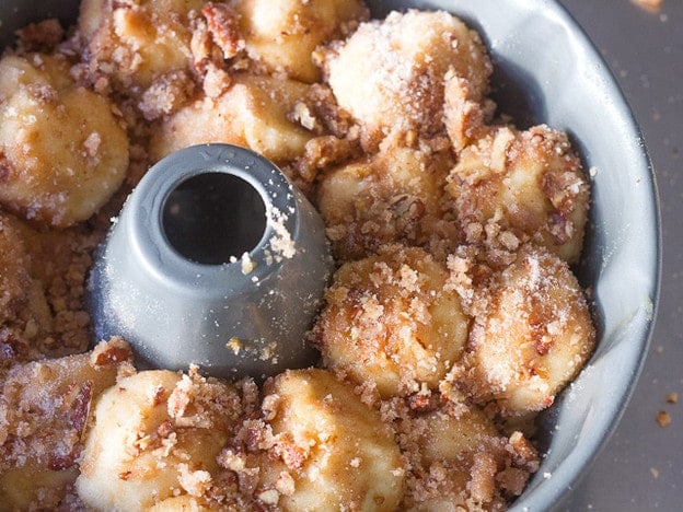 Monkey bread balls loaded into a bundt pan.