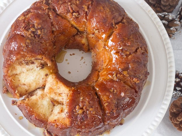 Overhead shot of Monkey break Hungarian coffee cake with a bite on side, served on a cake fancy cake holder stand