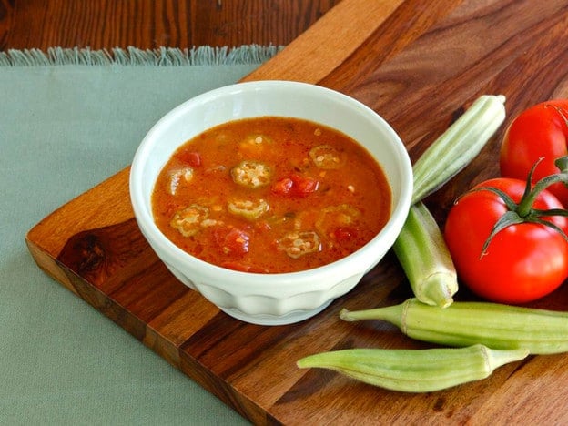 A bowl of Okra Soup, garnished with celery and tomatoes